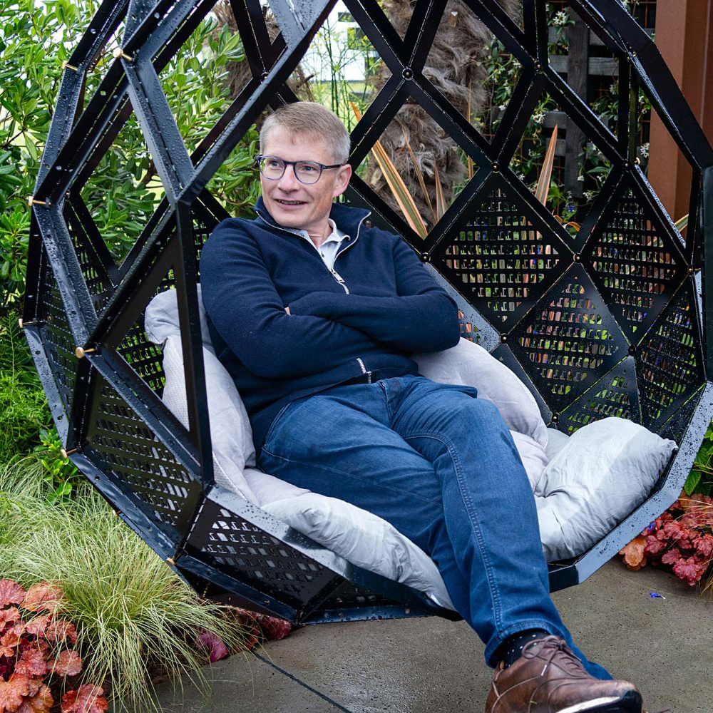 Paul Parker sat in a black hexagonal swing seat