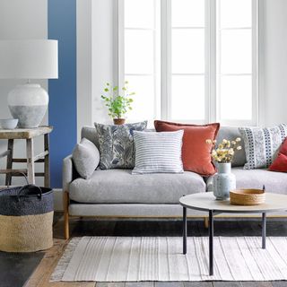 grey sofa with patterned cushions and coffee table in living room