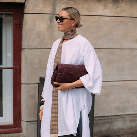 woman wearing a white t-shirt and a pair of sunglasses 