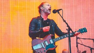 Thom Yorke from Radiohead singing on stage