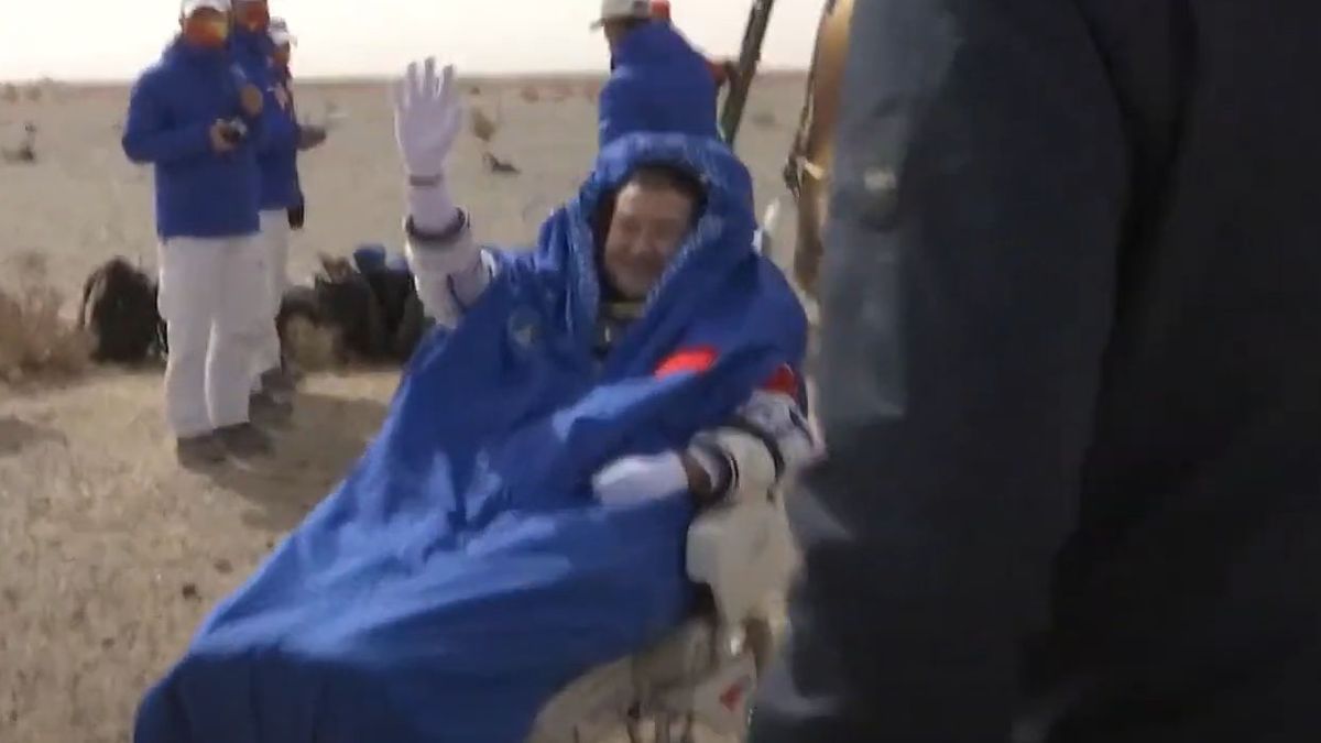 Chinese astronaut Zhai Zhigang, Shenzhou 13 commander, waves to recovery teams after exiting the Shenzhou 13 capsule after landing in the Gobi Desert on April 16, 2022.