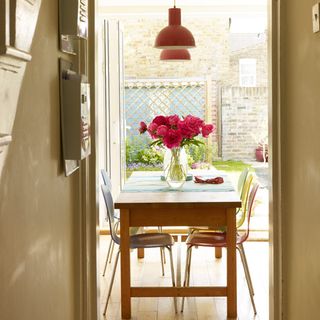 hallway with dining table and chairs with flower jar