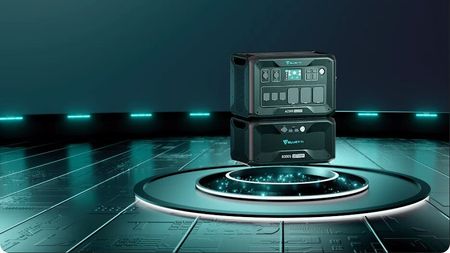 A Bluetti AC500 & B300S power system sitting in a dimly lit room lined with neon blue lights