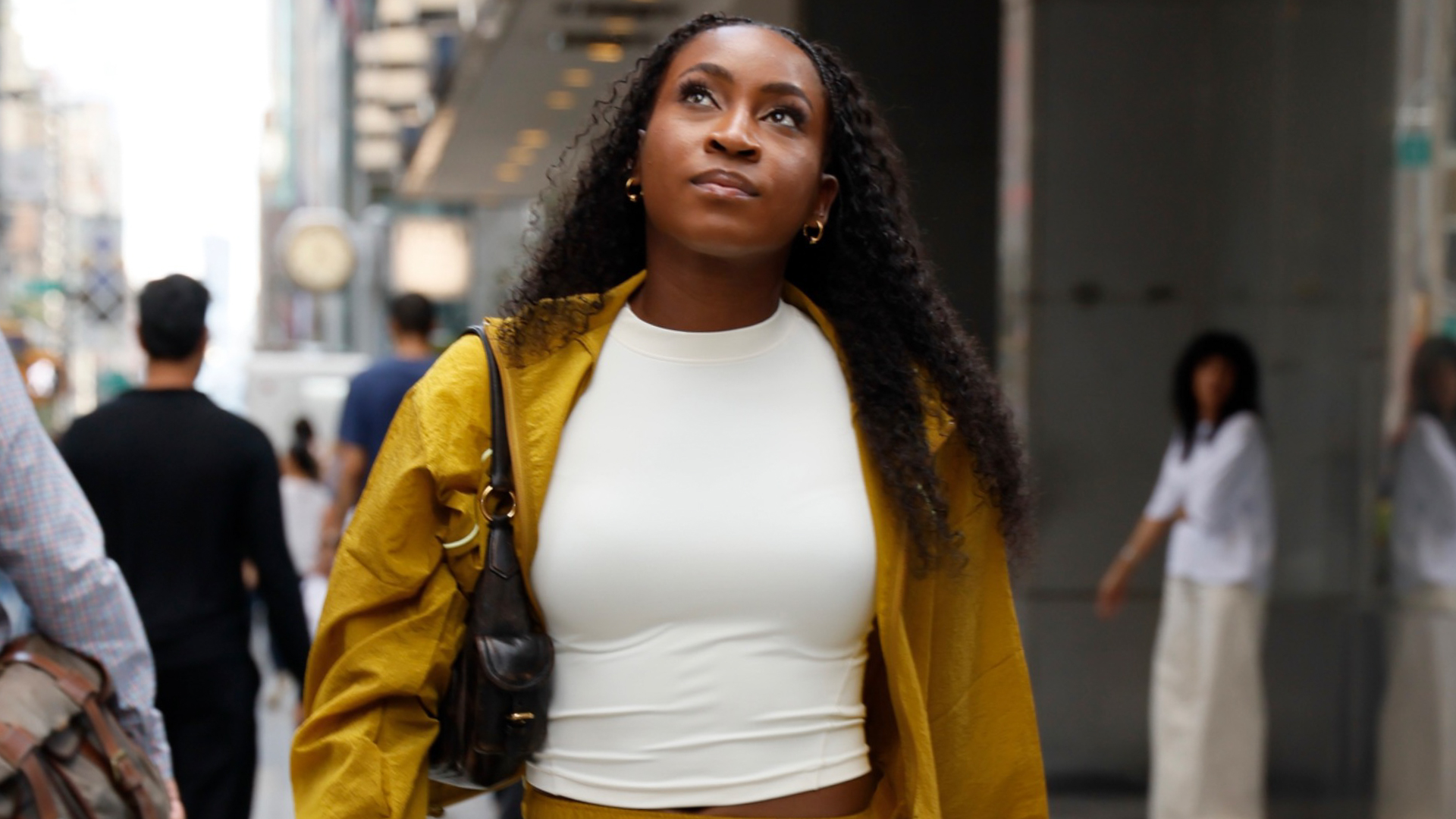 Coco Gauff's track skirt pulled off the mustard yellow color trend for fall with New Balance sneakers