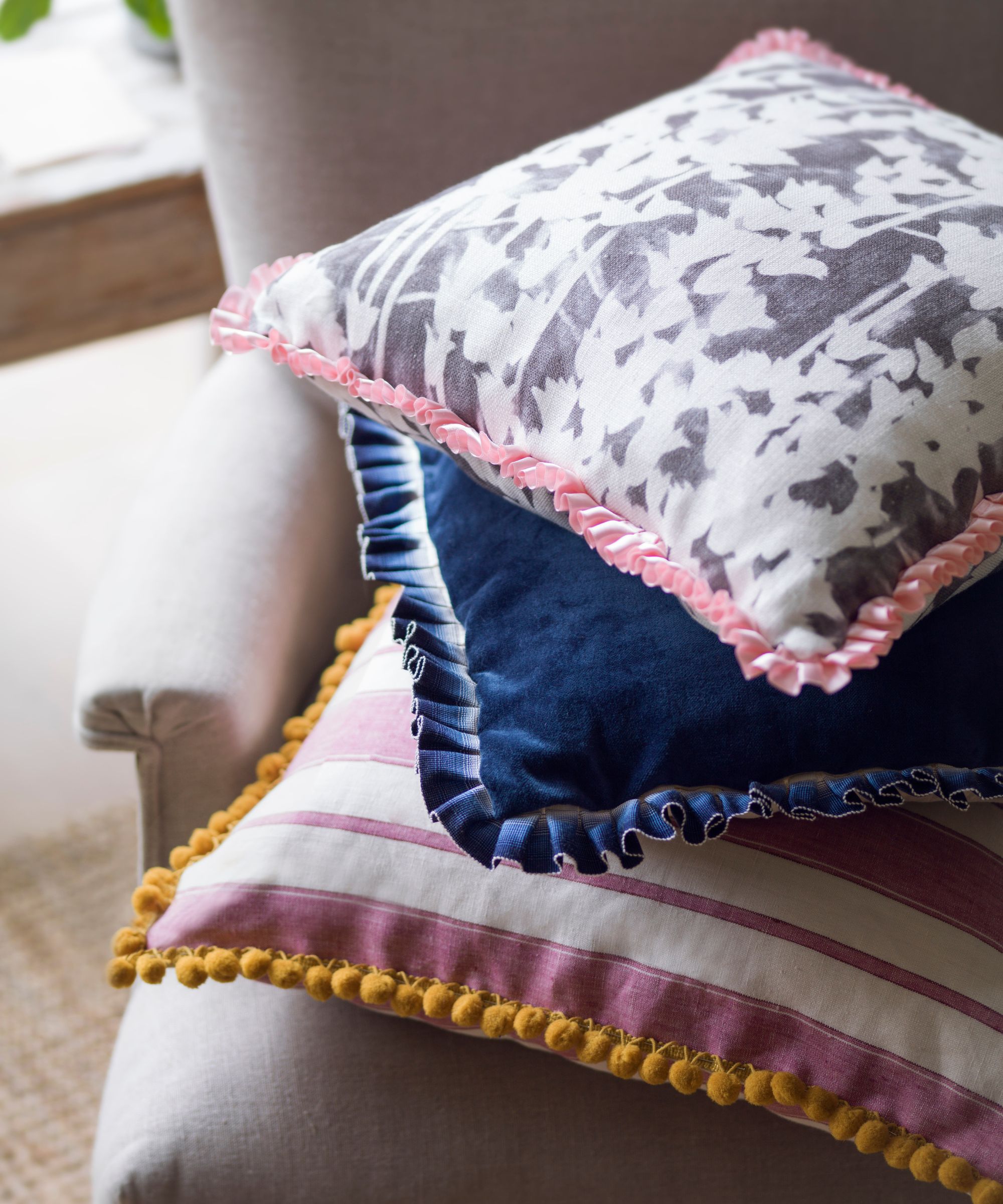 Colorful cushions stacked on a chair