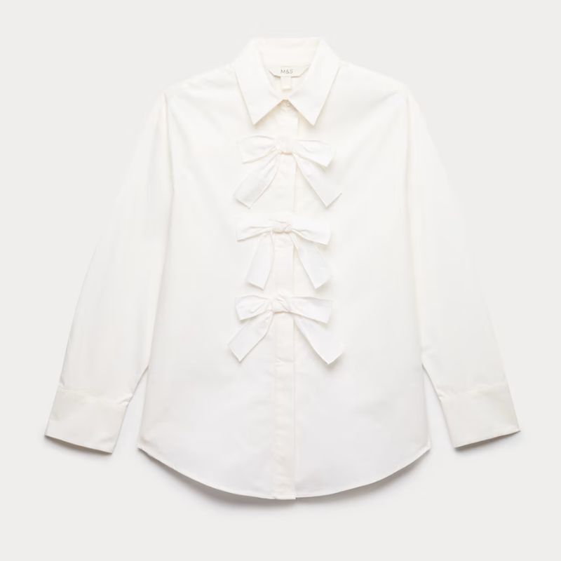 A cutout of a white blouse with bows down the front by M&amp;amp;S