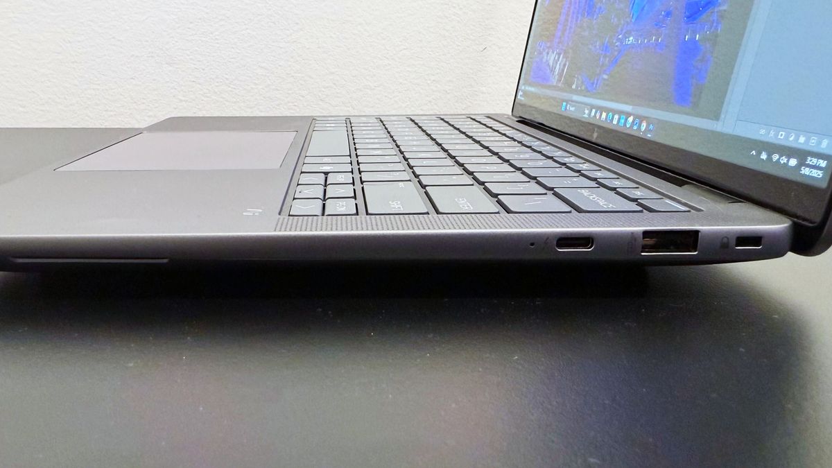 Close-up of the right-side ports on the HP ZBook Ultra 14 G1a mobile workstation open on a black desk against a white wall.