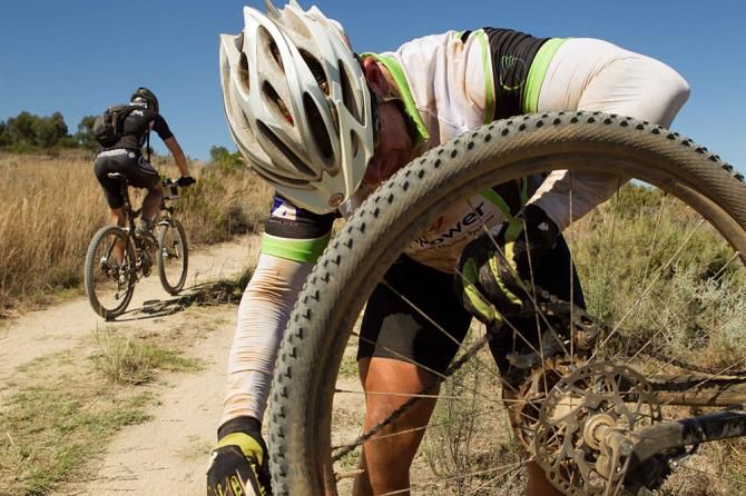 Riders stop to repair a broken chain