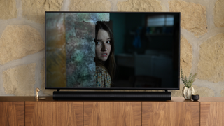 A TV playing No One will Save You is above a Sonos Arc soundbar