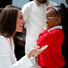 Britain's Catherine, Duchess of Cambridge, speaks to a girl as they attend the unveiling of the National Windrush Monument at Waterloo Station in London on June 22, 2022