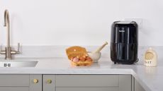 A tefal air fryer on a kitchen counter next to some cooking ingredients to explore can you make pancakes in an air fryer