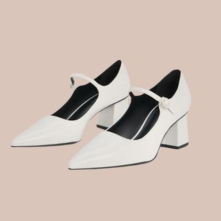 Flat lay image of white heeled pumps 