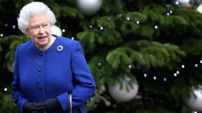 The Queen Christmas: the Queen stands in front of a decorated Christmas tree