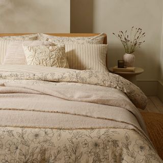 bedroom with cream bedding and cushions