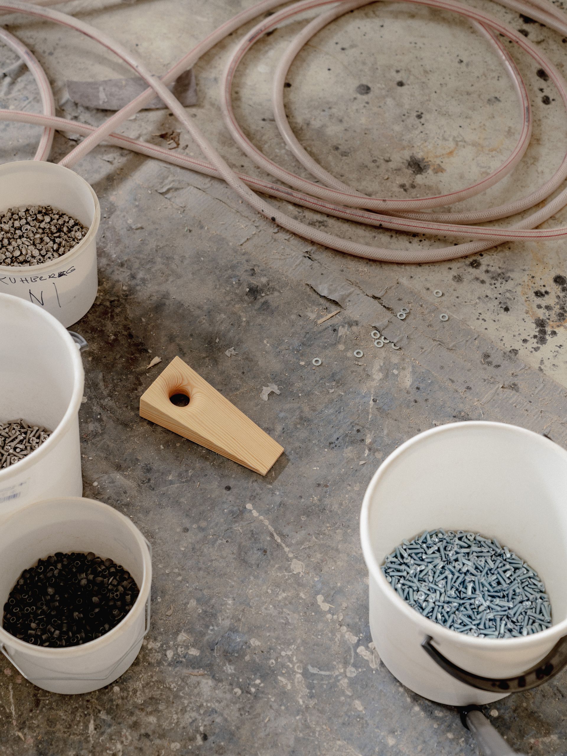 wooden door stopper among buckets