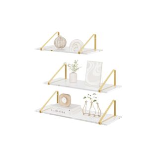 Three white and gold floating shelves