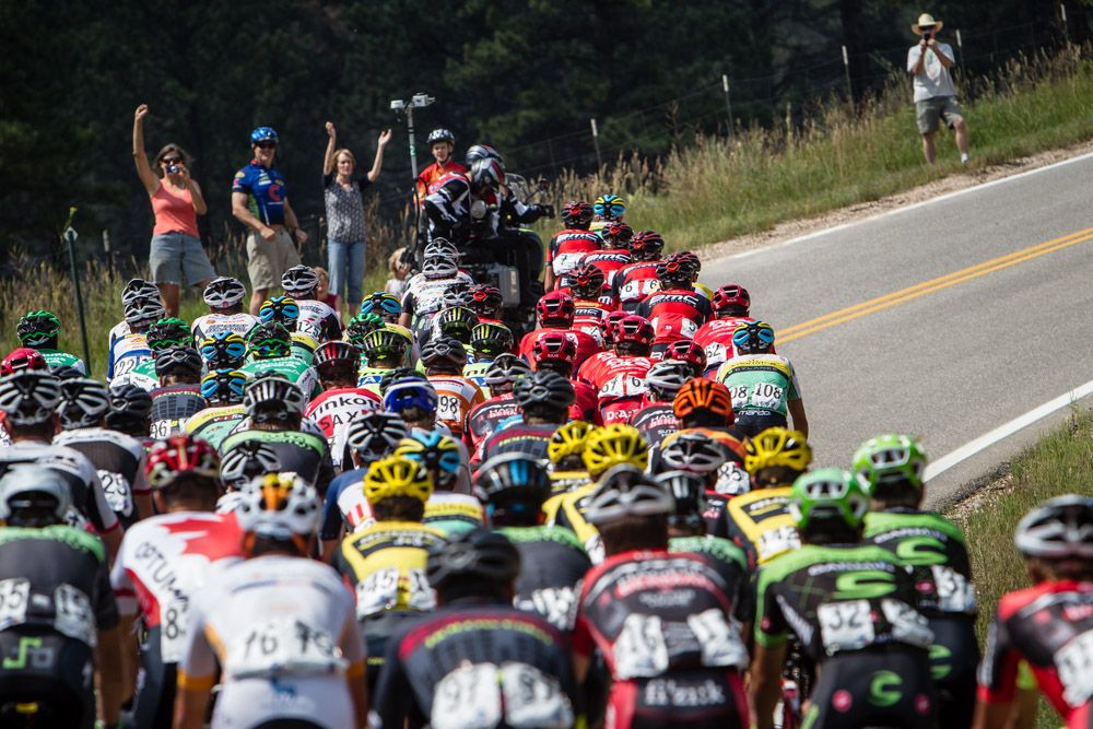 Fans cheer as the group hits the base of a climb