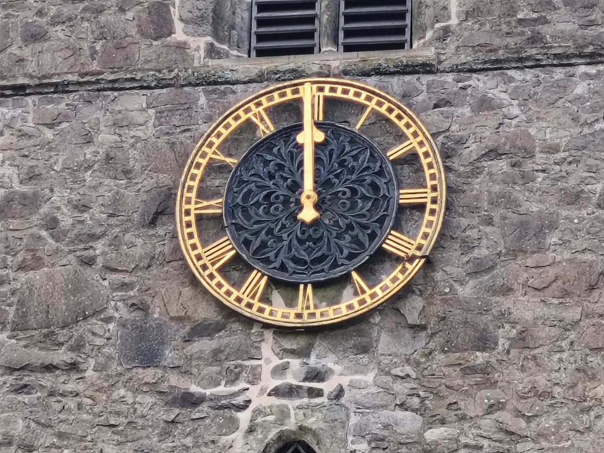 Close up of a clock on a stone church tower