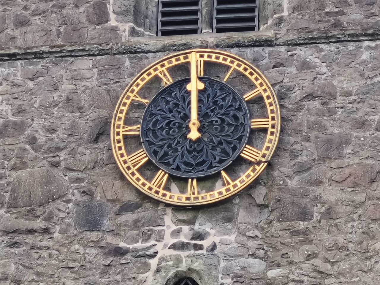 Close up of a clock on a stone church tower