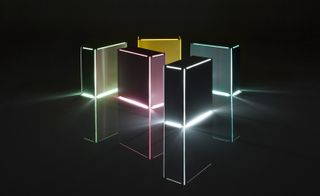 Five cuboid-shaped structures emitting light from their edges