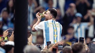 Argentina icon Lionel Messi holds the World Cup aloft after their success in 2022