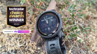 Garmin Forerunner 955 Solar on forest floor with TechRadar Choice Awards 2022 logo