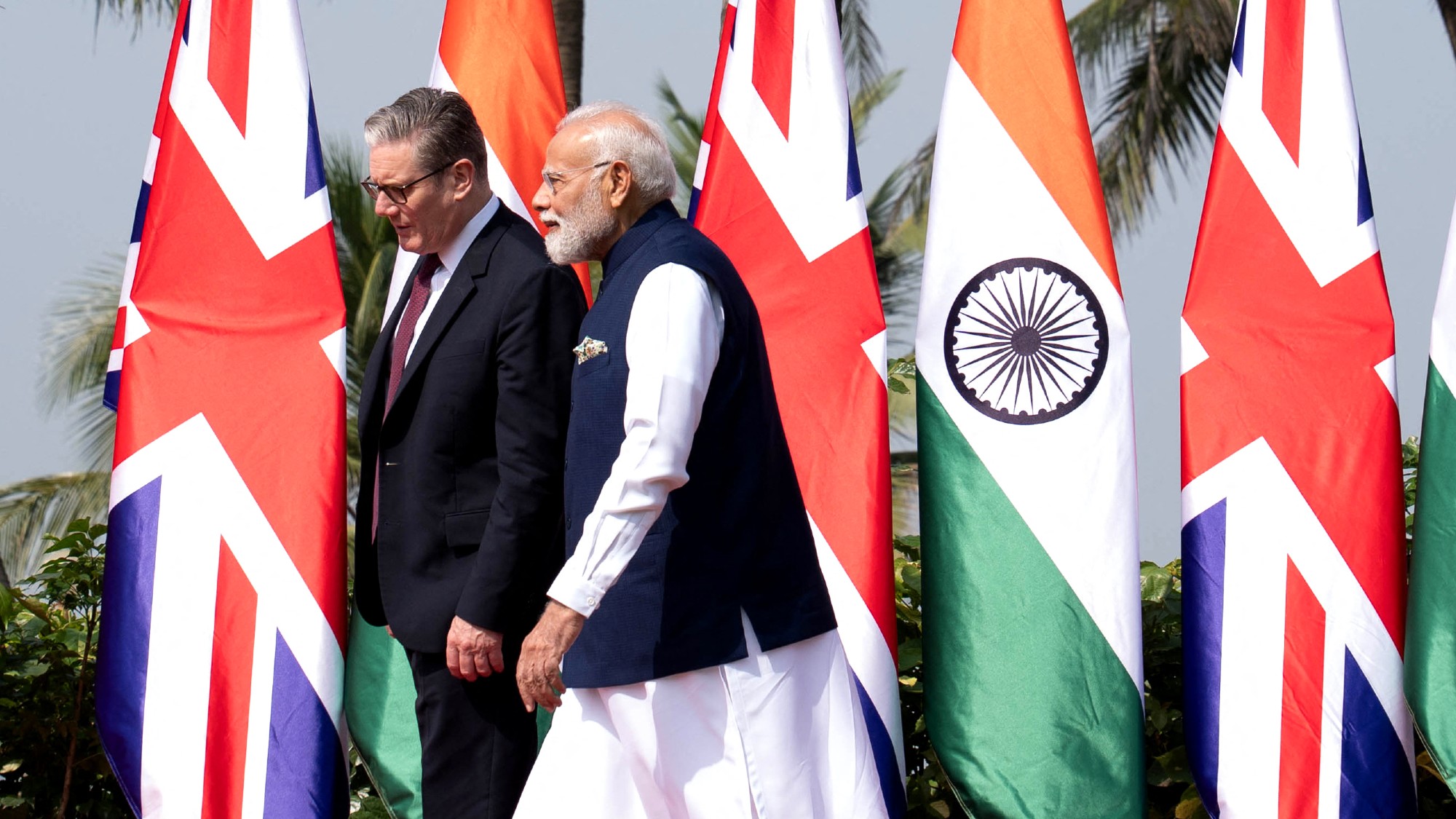 Narendra Modi (R) receives his British counterpart Keir Starmer, as he arrives at the Raj Bhavan in Mumbai 