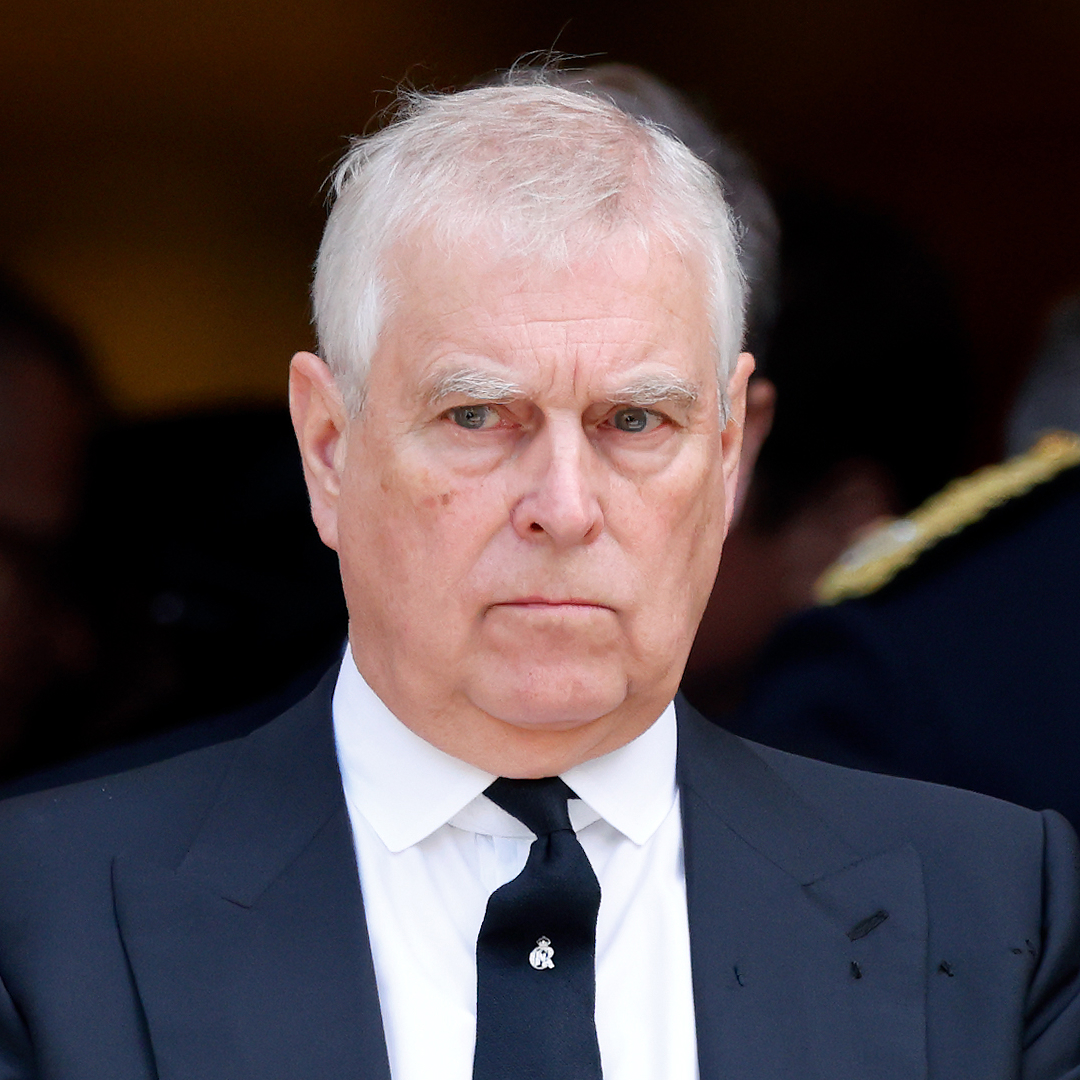 Prince Andrew wearing a suit and scowling