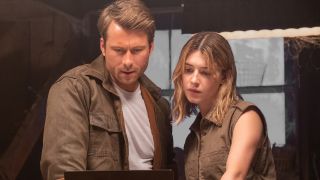 Glen Powell and Daisy Edgar-Jones looking over data together on a laptop in Twisters.