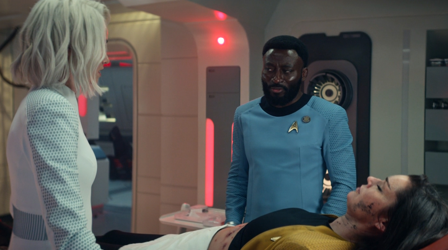 A scene from sickbay with Dr. M'Benga, nurse Christine Chapel and First Officer Una Chin-Riley on Star Trek: Strange New Worlds.