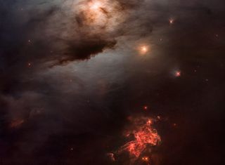 Portion of an image captured by the Hubble Space Telescope showing NGC 1333, a reflection nebula located 960 light-years away in the Perseus molecular cloud. 