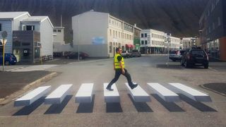 Someone walking across the floating zebra crossing.