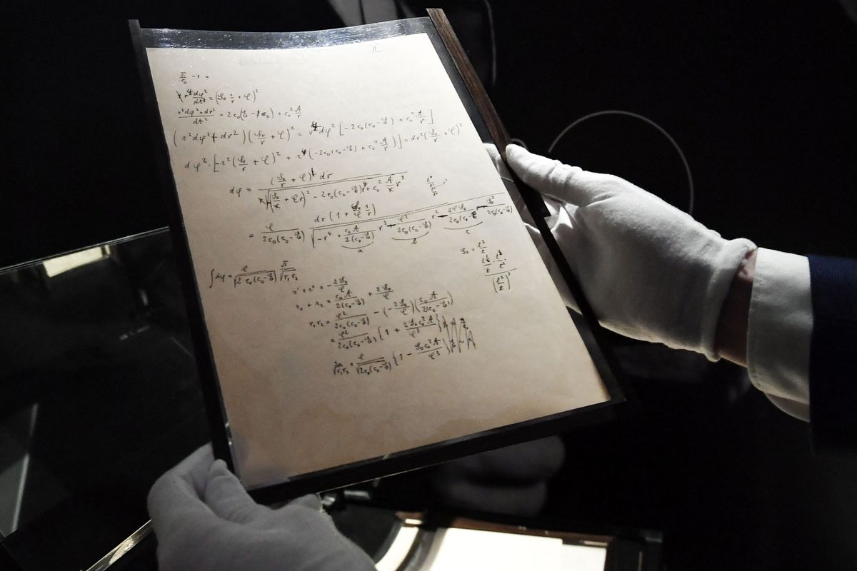 A picture taken on November 22, 2021 shows pages of one of the preparatory manuscript to the theory of general relativity of Albert Einstein, during their presention a day before being auctionned at Christie&#039;s auction house in Paris.