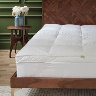 Wooden bed with mattress and mattress topper