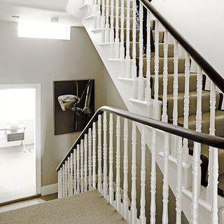 hallway with staircase carpet and white wall