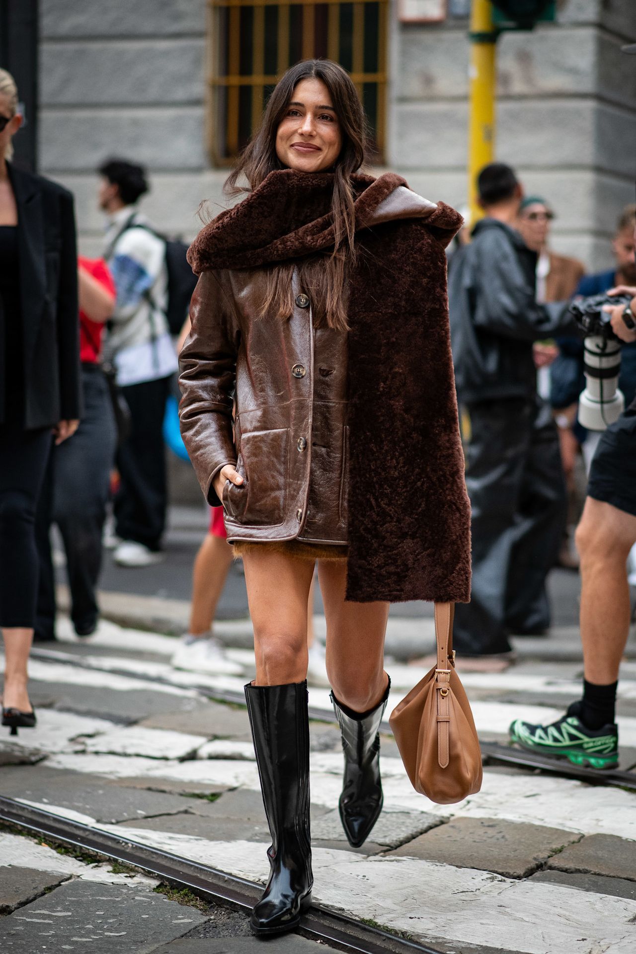 Fur accessory trend is shown in a street style photo of a woman