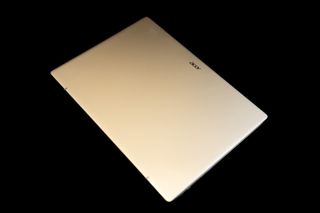 An Acer Swift Go 14 OLED laptop on a black background
