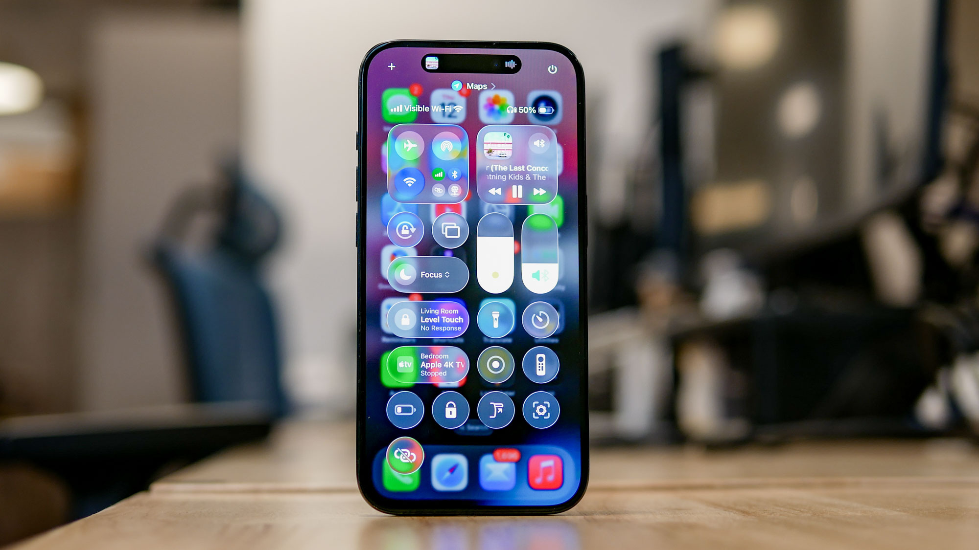 iOS 26 developer beta running on iPhone showing Liquid Glass interface.