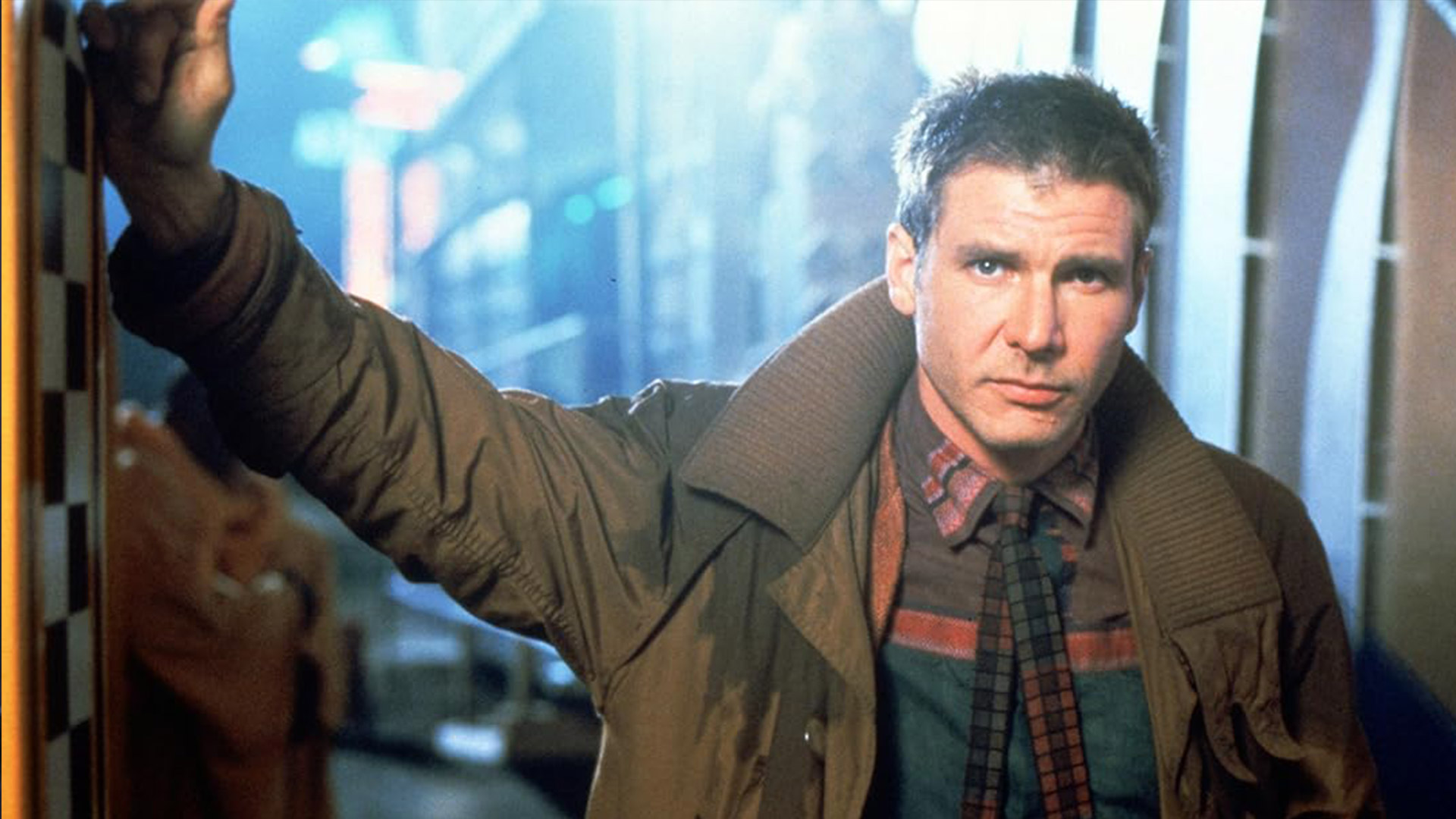 Harrison Ford leans against a wall in Blade Runner