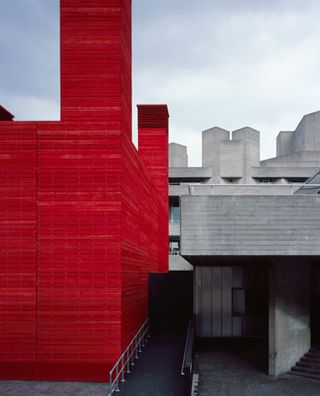 The Shed exterior showing timber cladding painted in red