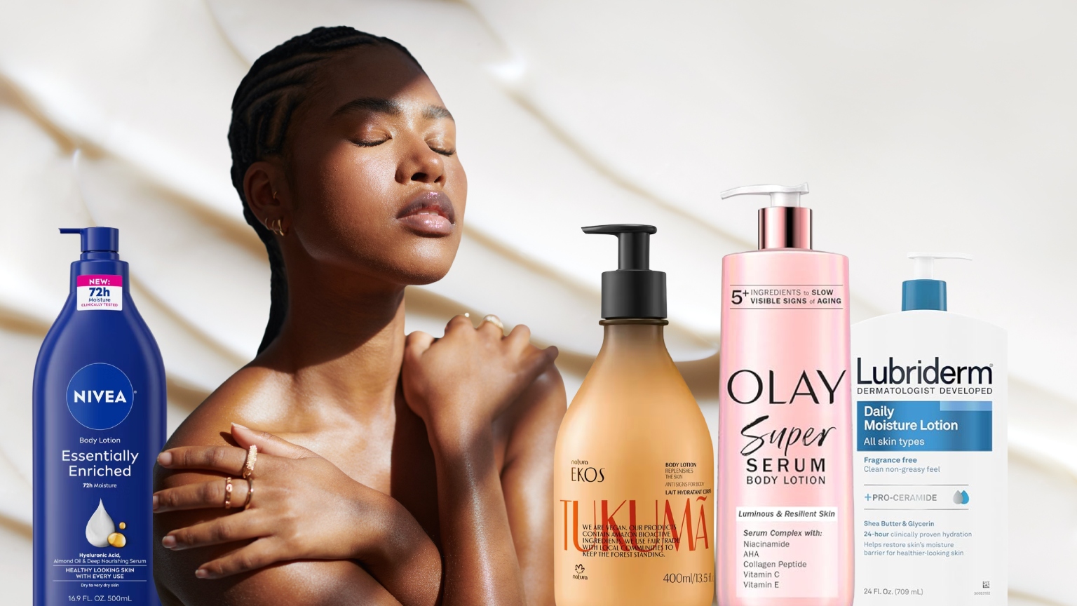 a woman with glowing skin surrounded by drugstore body lotion bottles