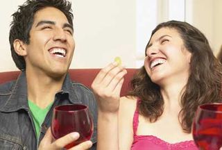 Couple laughing with drink