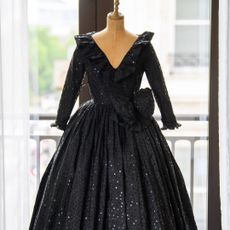 a black sequined dress on a mannequin at a Princess Diana press event