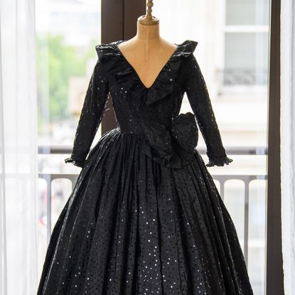 a black sequined dress on a mannequin at a Princess Diana press event