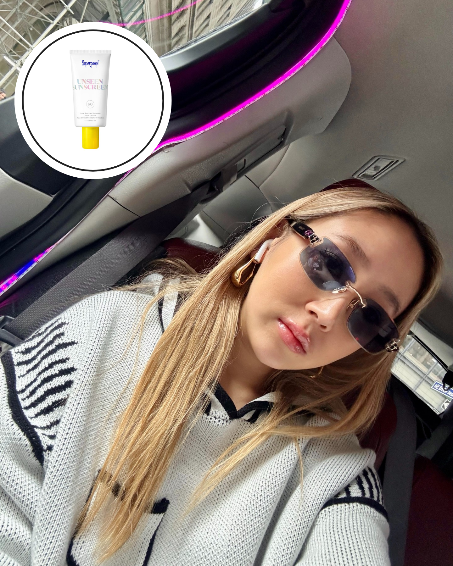 a woman with sunglasses in a silver hoodie with blonde hair in a car