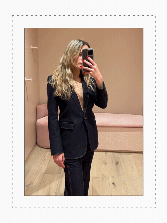 Eliza Huber in the dressing room at Me+Em's new NYC store wearing a denim suit.