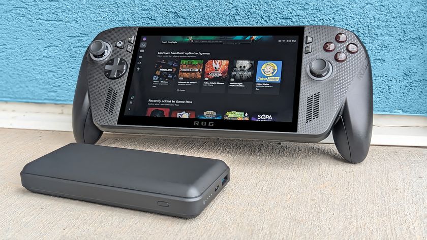 Xbox Ally X leaning against a blue wall with a power bank in front of it. 