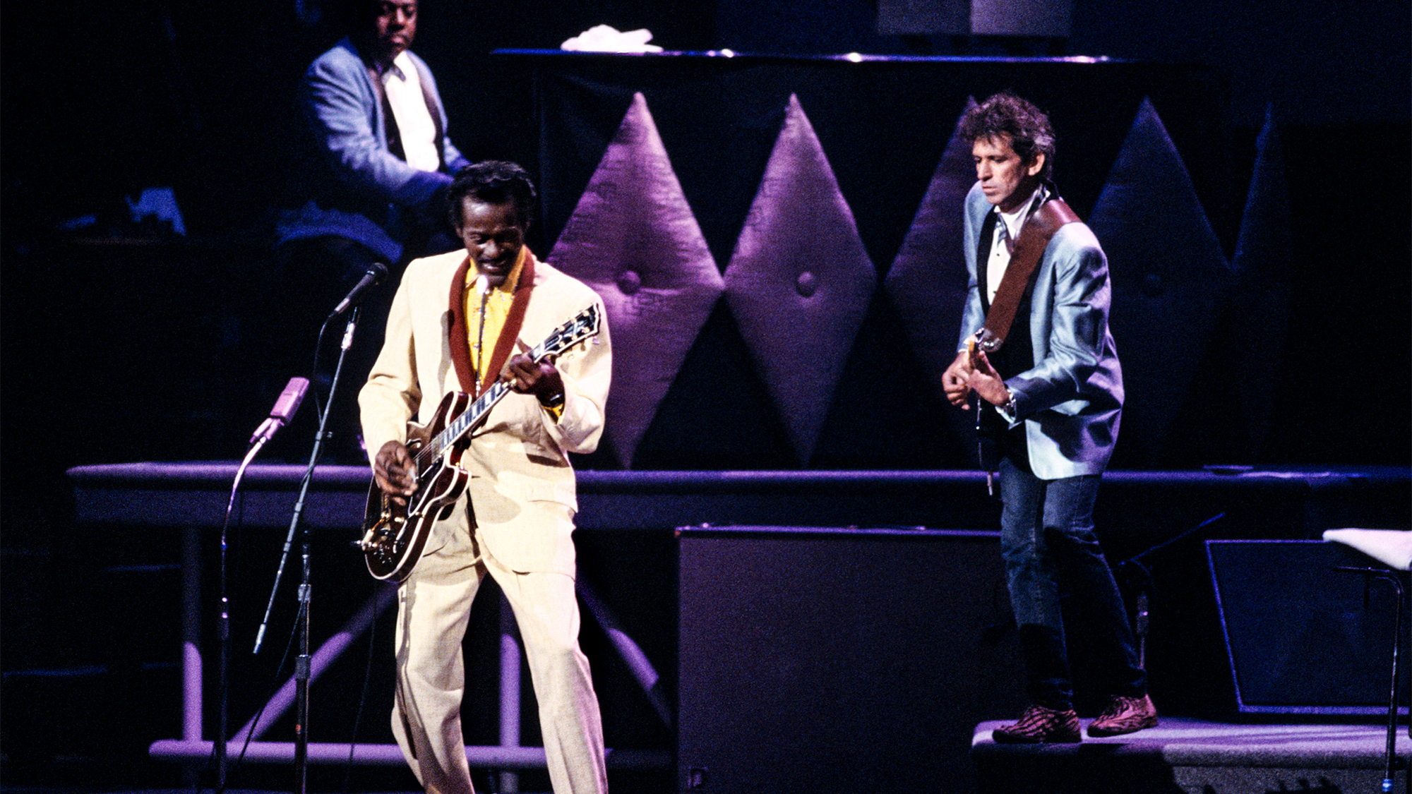 Chuck BERRY and Keith RICHARDS and Johnnie JOHNSON; Johnnie Johnson, Chuck Berry and Keith Richards performing on stage at Chuck's 60th Birthday Concert for the filming of &amp;quot;Hail Hail Rock &amp;amp; Roll&amp;quot;