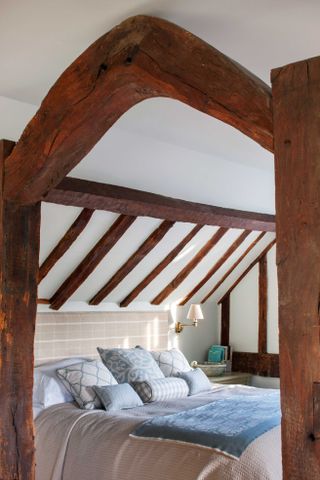 oak frame bedroom with beams and duvet