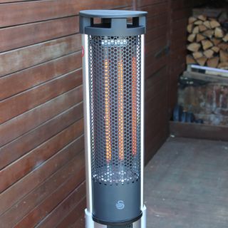 The Swan Column patio heater with two elements lit